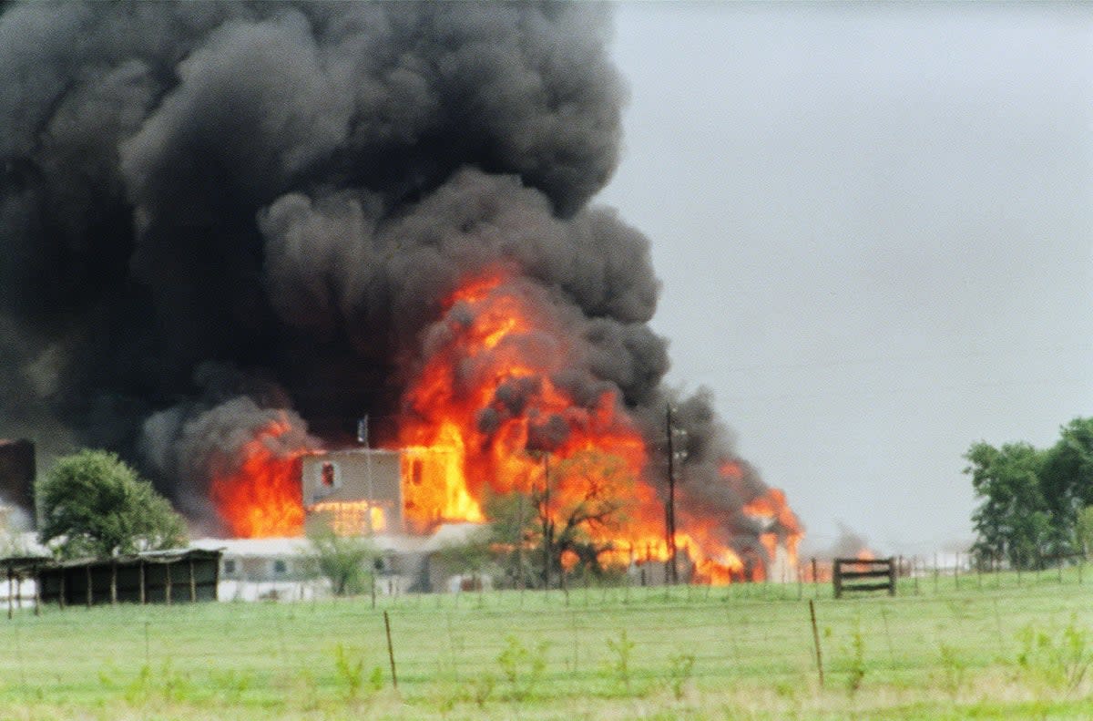 The Branch Davidian cult compound observation tower in Waco is engulfed in flames on 19 April 1993 (TIM ROBERTS/AFP via Getty Images)