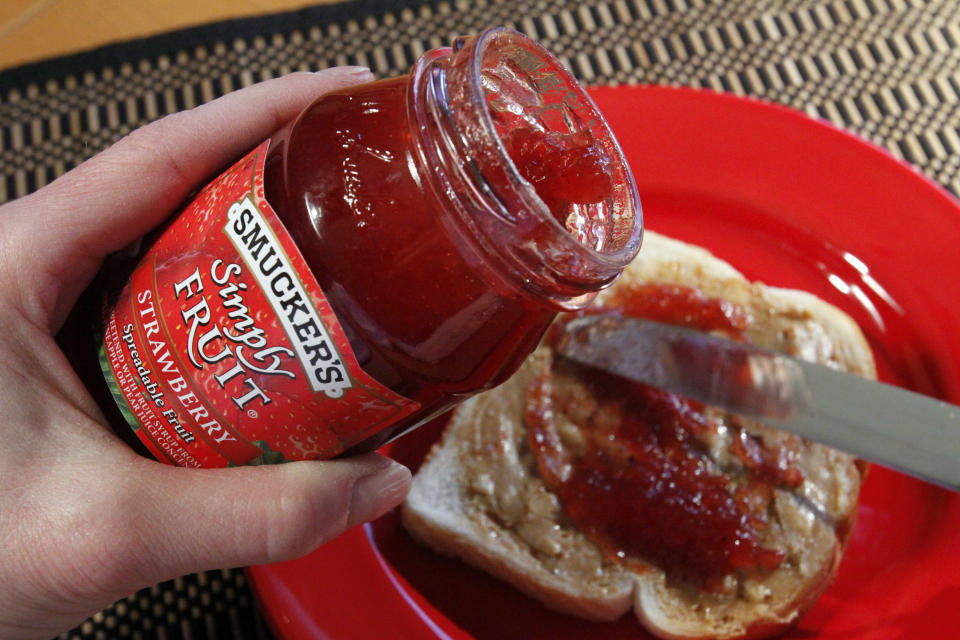 FILE - In this Feb. 14, 2011 file photo, Smucker's Simply Fruit Strawberry is spread atop peanut butter in Pittsburgh. Anyone with unpaid parking fines at the University of Alaska, Anchorage campus has the option to reduce or cover the cost of their tickets with peanut butter and jelly. KTUU-TV reported the university would take donations for their annual payment tradition until Nov. 8 to help combat student hunger. Officials say the food goes to students in need. (AP Photo/Gene J. Puskar, File)