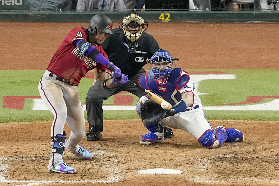 Arizona Diamondbacks' Ketel Marte hits a RBI double off Texas Rangers starting pitcher Nathan Eovaldi during the fifth inning in Game 1 of the baseball World Series Friday, Oct. 27, 2023, in Arlington, Texas. (AP Photo/Tony Gutierrez)