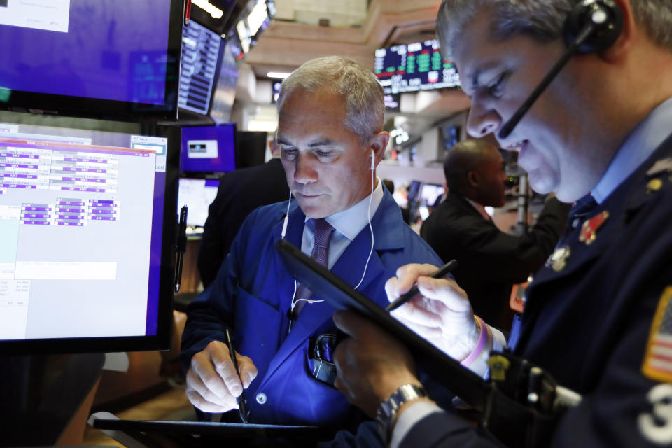 Trader Timothy Nick, left, works on the floor of the New York Stock Exchange, Friday, Sept. 13, 2019. Stocks are having a mixed performance early on Wall Street Friday as gains in banks and energy companies are offset somewhat by a drop in technology stocks. (AP Photo/Richard Drew)