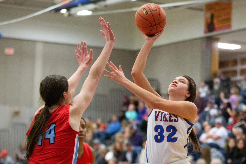 Seaman sophomore Maddie Gragg (32) shoots a layup over Shawnee Heights on senior Rachel Swift (44) in the second half of the game Friday, Jan. 12, 2024. Seaman beat Heights 69-39.