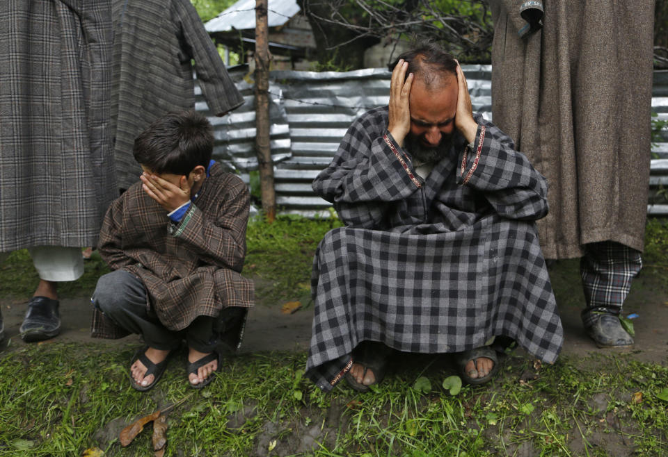 FILE - In this Wednesday, June 7, 2017, file photo, Kashmiri relatives cry during the funeral of civilian Adil Magray, was killed when government forces opened fire on protesters during a search operation to flush out Kashmiri rebels, at Shopian, about 60 kilometers (38 miles) south of Srinagar, Indian controlled Kashmir. India has long seen the Kashmiri struggle for self-determination as Islamabad's proxy war against New Delhi. For years, the region has been patrolled by military, paramilitary and armed police and remains one of the most militarized regions in the world. The region is one of the most heavily militarized in the world, patrolled by soldiers and paramilitary police. Most Kashmiris resent the Indian troop presence and support the rebels. (AP Photo/Mukhtar Khan, File)