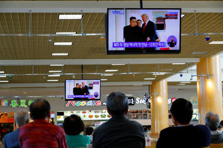 FILE PHOTO: People watch from a shopping mall food court in the Los Angeles neighborhood of Koreatown as Singapore hosted a summit between U.S. President Donald Trump and North Korean leader Kim Jong Un, in Los Angeles, California, U.S., June 11, 2018. REUTERS/Mike Blake/Files