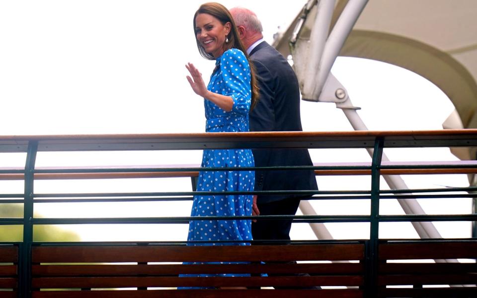 The Duchess waves to fans as she walks from the Millennium Building to Centre Court - Adam Davy/PA Wire