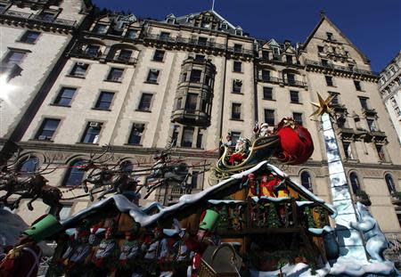 Santa Claus waves as he rides on his float down Central Park West during the 87th Macy's Thanksgiving Day Parade in New York November 28, 2013. REUTERS/Gary Hershorn