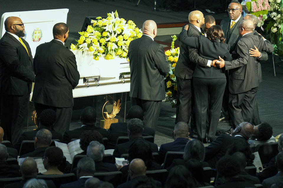 Family members embrace near the casket during funeral services for former U.S. Rep. Eddie Bernice Johnson at Concord Church on Tuesday, Jan. 9, 2024, in Dallas. (Smiley N. Pool/The Dallas Morning News via AP, Pool)