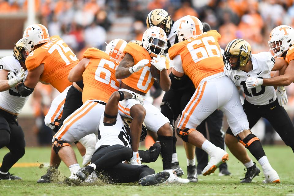 Tennessee running back Jaylen Wright (0) is tackled by Vanderbilt players during a football game between Tennessee and Vanderbilt at Neyland Stadium in Knoxville, Tenn., on Saturday, Nov. 25, 2023.