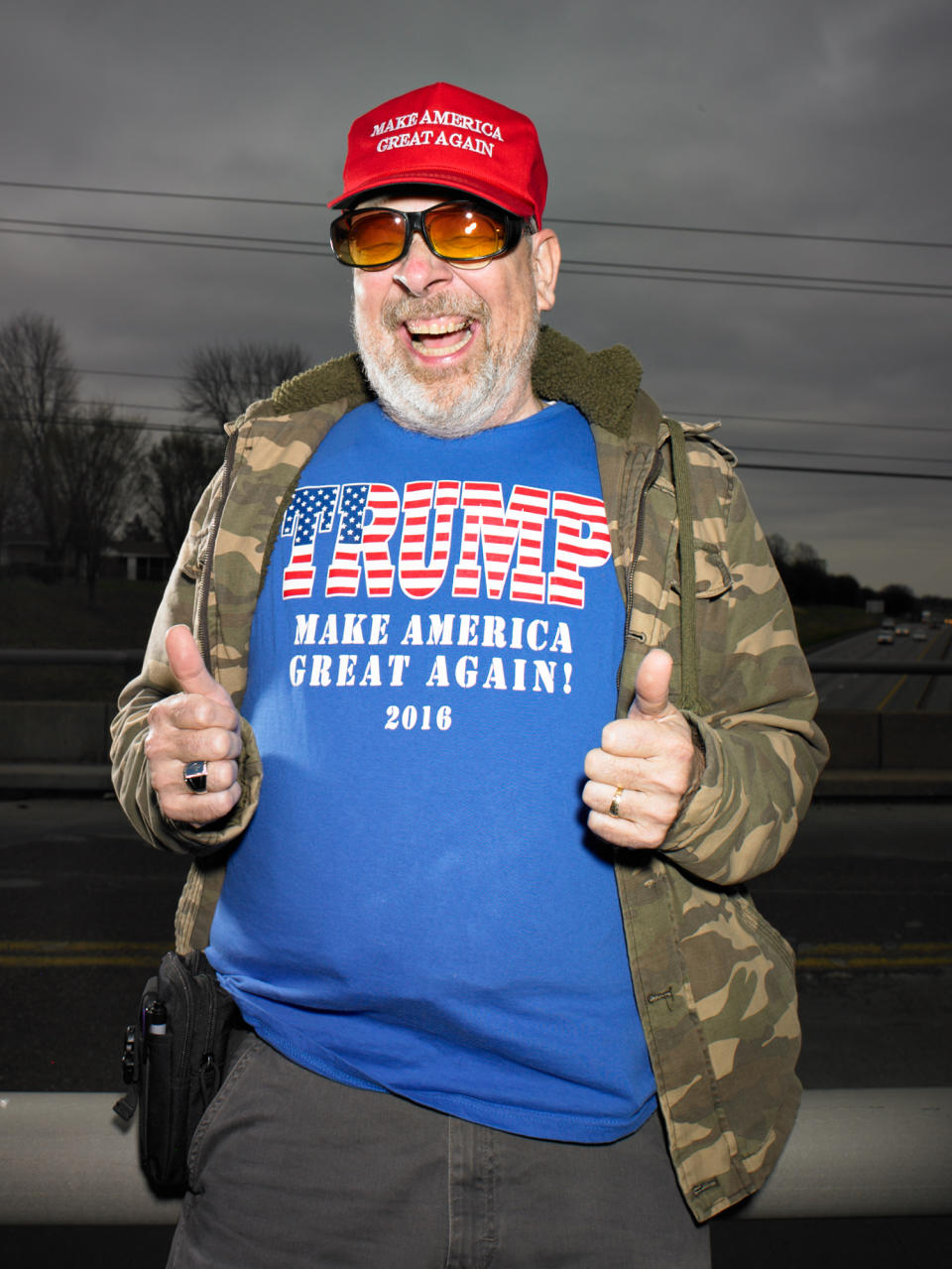 <p>“Roger Frederick, is a member of Overpasses for America, ‘a nonpartisan’ grassroots movement that values the U.S. Constitution and seeks to have government-elected officials represent its values. On this day, the group was voicing support for the president. He isn’t shy about whom he voted for.”<br>(Photograph and caption by Naomi Harris) </p>