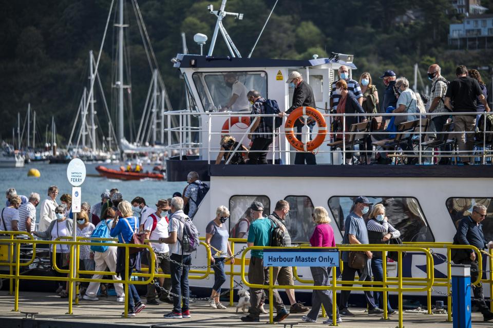 Passengers wearing face coverings to reduce the spread of coronavirus, disembark the Dartmouth Princess ferry from Kingswear to Dartmouth, on the River Dart in Dartmouth, Devon.