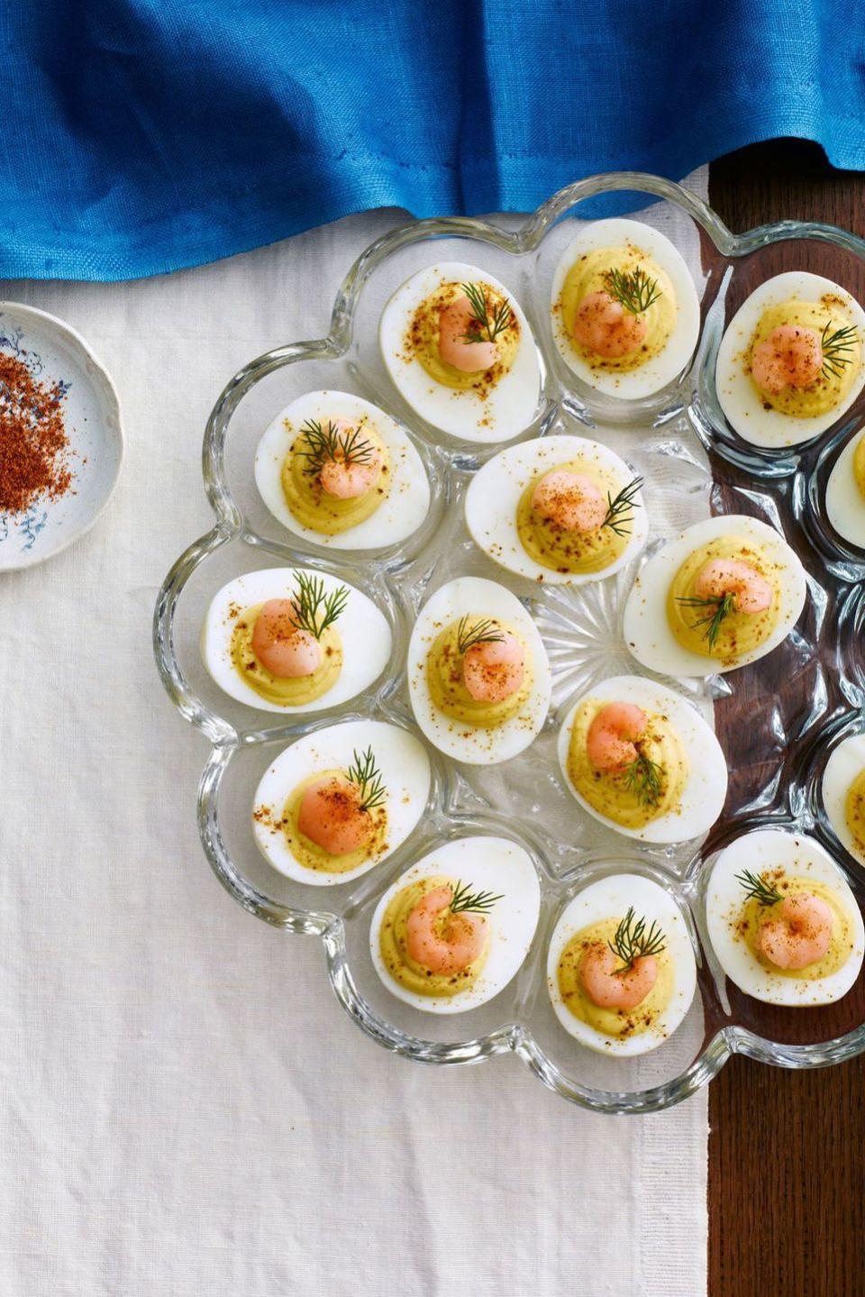 deviled eggs with old bay shrimp in a glass deviled egg plate