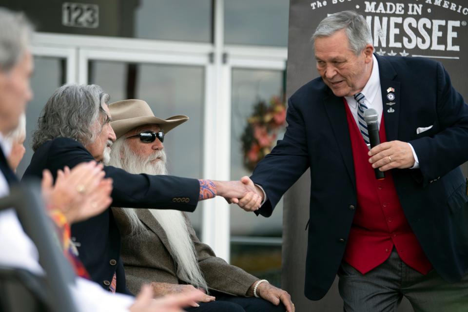 Tennessee Rep. John Ragan shakes hands with Richard Sterban of the Oak Ridge Boys during a ceremony on Monday, November 20, 2023 in Oak Ridge, Tenn. to recognizes the group's connections and history to Oak Ridge.