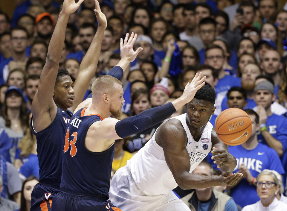 Duke's Zion Williamson passes the ball while Virginia's Jack Salt and De'Andre Hunter, left, defend during the first half of an NCAA college basketball game in Durham, N.C., Saturday, Jan. 19, 2019. (AP Photo/Gerry Broome)