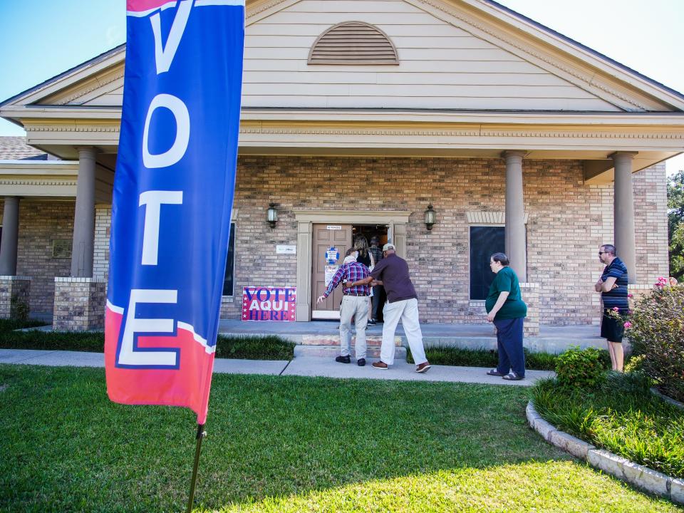 Voters wait in line Tuesday at the Ben Hur Shrine Center polling place in North Austin. The line stretched to the parking lot, with voters eager to cast their ballots.