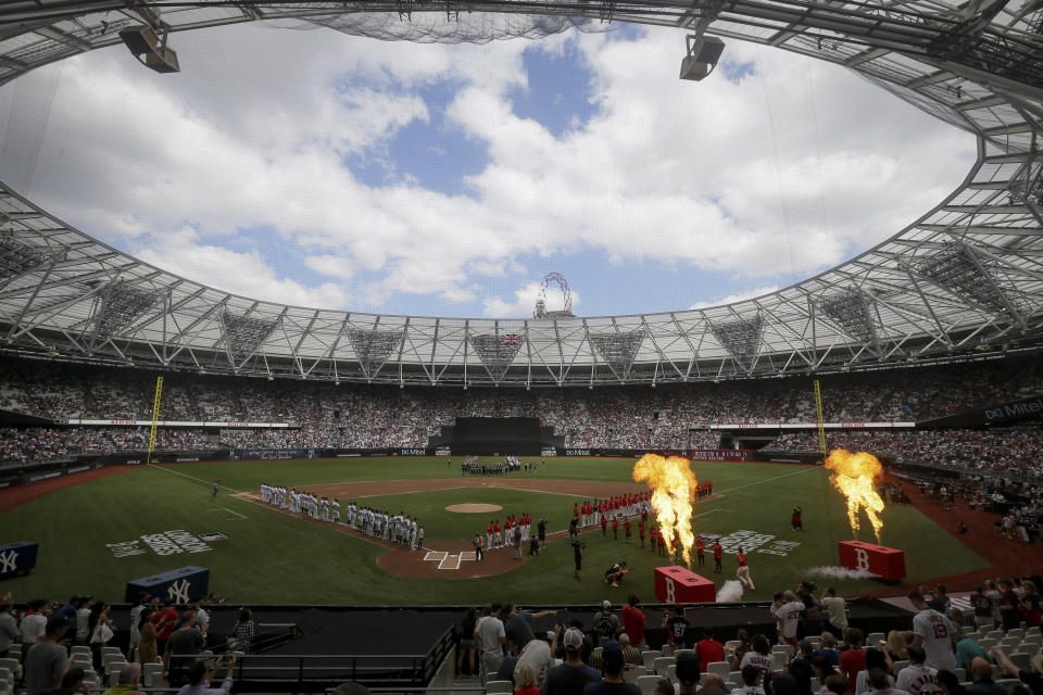 The New York Yankees, left, and the Boston Red Sox line up for the national anthem before a baseball game in London, Sunday, June 30, 2019. (AP Photo/Tim Ireland)