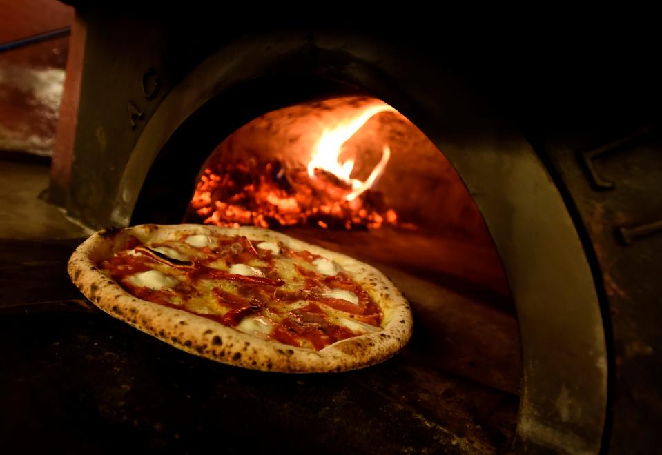 A DeSano Pizza Bakery diavola pizza is removed from the oven on Tuesday, Dec. 6, 2022, in Nashville, Tenn.
