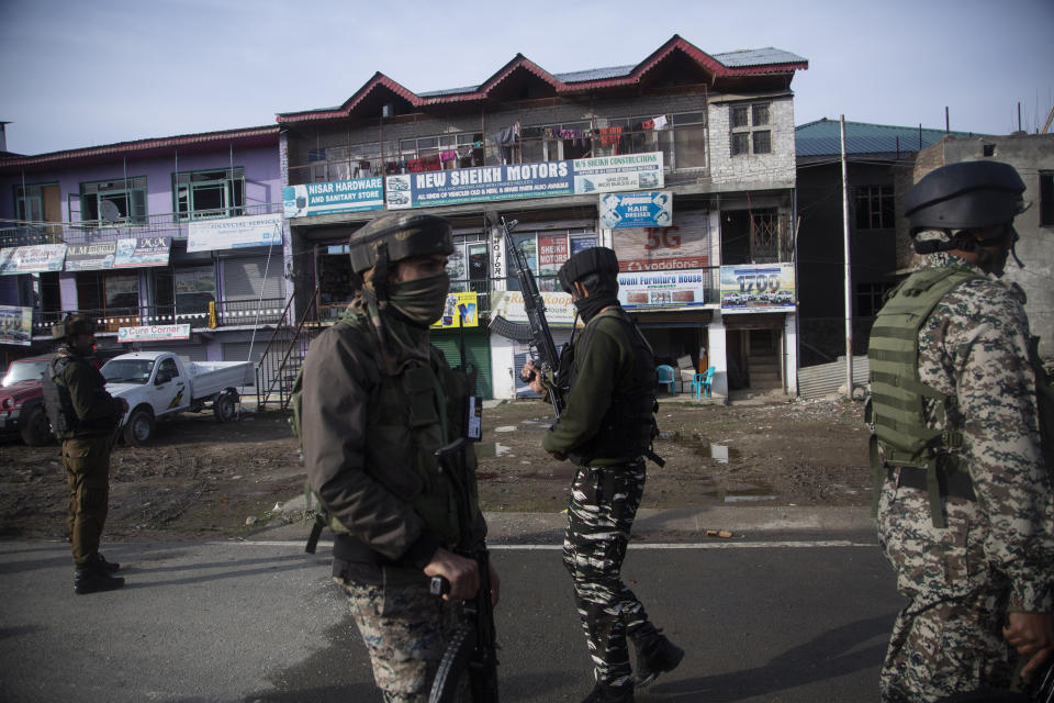 Indian soldier stand guard at the site of an attack on the outskirts of Srinagar, Indian controlled Kashmir, Thursday, March 25, 2021. Rebels fighting against Indian rule in disputed Kashmir Thursday attacked a paramilitary patrol, killing two soldiers and injuring two others, an official said. (AP Photo/Mukhtar Khan)