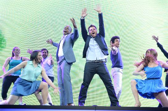 This publicity image released by USA Network shows Dule Hill, center left, and James Roday, center right, performing a musical number at the 2013 USA Network Upfront at Pier 36 in New York on Thursday, May 16, 2013. At the network's annual upfront presentation for advertisers Thursday, James Roday and Dule Hill said for the show's eighth season, which they're filming now, Roday said the cast and crew are planning to remake a previous episode. (AP Photo/USA Network, Andrew Walker)