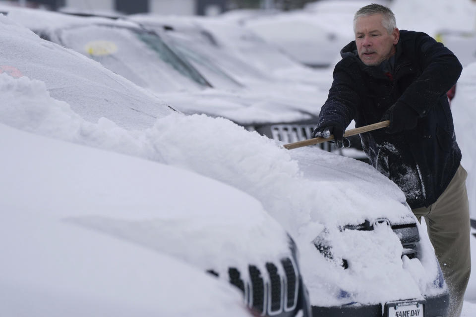 Darren LaCrego, a salesman at the West Herr Jeep dealership, clears snow off of vehicles in the lot on Southwestern Boulevard in Orchard Park, N.Y. on Tuesday, Nov. 28, 2023. (Derek Gee/The Buffalo News via AP)