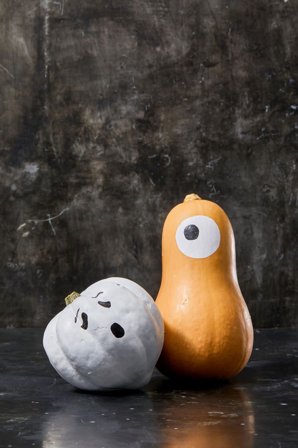 <p>These super-cute painted ghosts aren't pumpkins at all, but that doesn't make them any less festive. Play around with different shapes from your grocery store or farmer's market, and add cute, playful faces. </p>