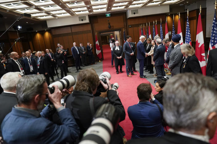 Canadian Prime Minister Justin Trudeau stands with President Joe Biden as he greets people at Parliament Hill, Friday, March 24, 2023, in Ottawa, Canada. (AP Photo/Andrew Harnik)