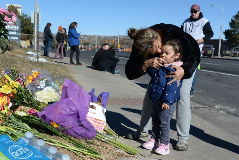Nelly Brusnell signs a cross on the chest of Ivanna Brusnell after placing flowers near a gay nightclub in Colorado Springs, Colo., Sunday, Nov. 20, 2022, where a fatal shooting occurred late Saturday night. Police say a 22-year-old gunman opened fire at the gay nightclub, Club Q, killing several people and leaving multiple people injured before he was subdued by "heroic" patrons. (AP Photo/Geneva Heffernan)
