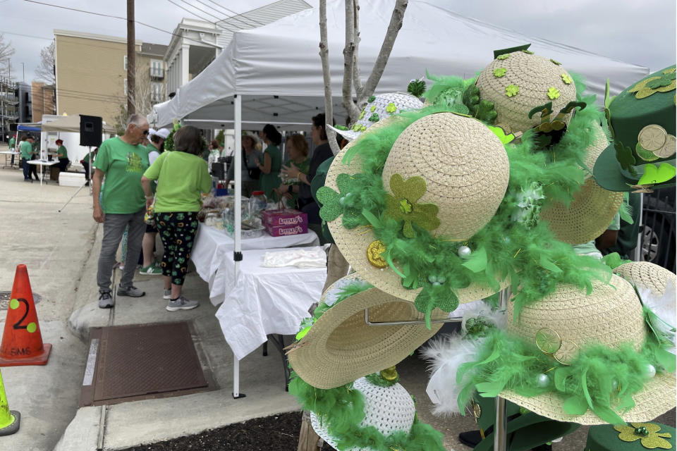 An array of hats decorated for St. Patrick's Day is displayed at a park in New Orleans during an Irish-themed fundraiser for a local school on Thursday, March 14, 2024. Although New Orleans is better known for French, Spanish, African American and Caribbean influences, the Irish have played a major role in the city's history, and the city celebrates the legacy with parades and parties centered around the March 17 St. Patrick's Day holiday. (AP Photo/Kevin McGill)