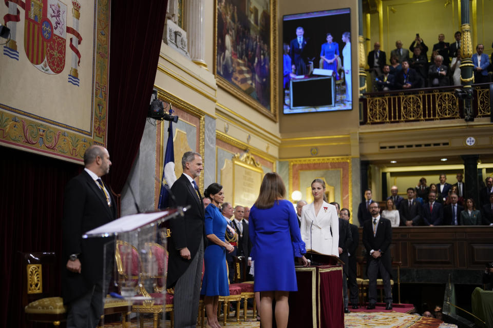 Princess Leonor, right, next to Spanish King Felipe VI and Queen Letizia, swears allegiance to the Constitution, during a gala event that makes her eligible to be queen one day, in Madrid on Tuesday, Oct. 31 2023. The heir to the Spanish throne, Princess Leonor, is to swear allegiance to the Constitution on her 18th birthday Tuesday, in a gala event that paves the way to her becoming queen when the time comes. Leonor is the eldest daughter of King Felipe and Queen Letizia. (AP Photo/Manu Fernandez)