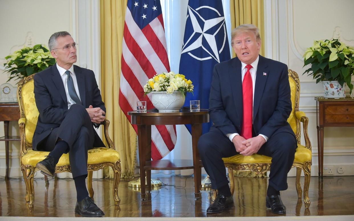 Jens Stoltenberg, the NATO Secretary-General, with Donald Trump in December last year. - Rex