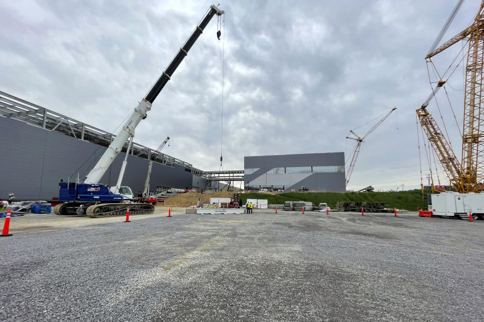 Construction continues on the Wolfspeed factory in Siler City, N.C., on March 26, 2024. The new factory will soon produce advanced wafers for computer chips. Automaker Vinfast is scheduled to open a factory next year. Both projects stem in large part from incentives that Biden signed into law. Biden has campaigned on how his policies helped pump hundreds of billions of dollars in private and federal investment into companies. But so far, the investments haven’t significantly swayed a public concerned about inflation. (AP Photo/Josh Boak)