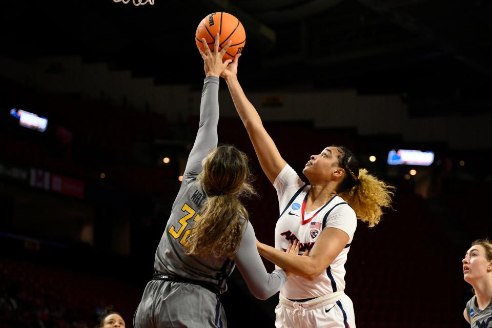 Arizona forward Esmery Martinez, right, goes to the basket against West Virginia guard Kyah Watson (32) in the first half of a first-round college basketball game in the NCAA Tournament, Friday, March 17, 2023, in College Park, Md. (AP Photo/Nick Wass)