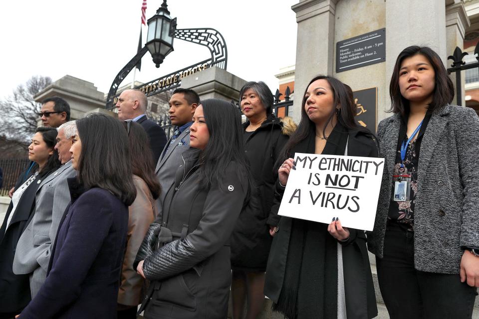 Members of the Asian American Commission hold a press conference on the steps of the Massachusetts State House to condemn racism toward the Asian American community because of coronavirus on March 12 in Boston. (John Tlumacki/The Boston Globe via Getty Images)