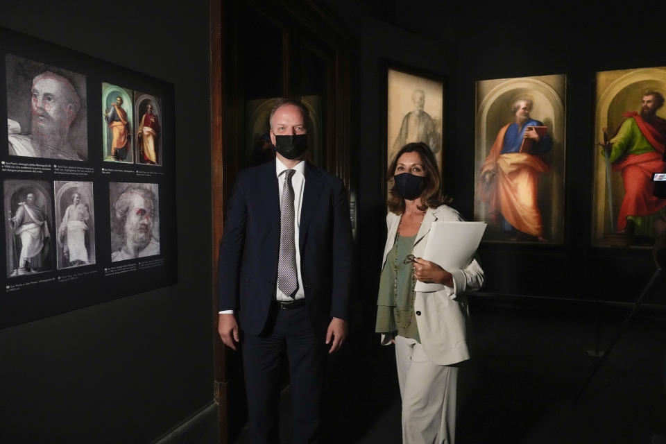Uffizi Museum director Eike Schimidt, left, and Vatican Museums director Barbara Jatta pose for the media at the presentation of the "St.Peter and St.Paul by Fra Bartolomeo and Raffaello" exhibition, at the Vatican Museums, at the Vatican, Friday, Sept. 24, 2021. Two restored paintings, started by Fra Bartolomeo and finished by Raffaello after his death, between 1513 and 1518, kept in the Papal Apartments and unseen by the public for decades, and the their preparatory cartoons by Fra Bartolomeo, coming from Forence's Uffizi Museum, will be on display from Sept. 25, 2021 to Jan. 9, 2022. (AP Photo/Andrew Medichini)
