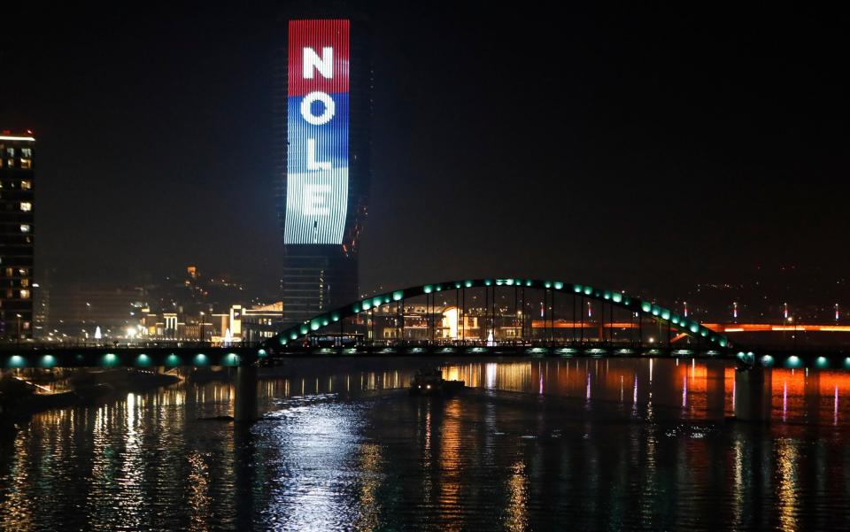 The word 'Nole', a nickname of Serbian tennis player Novak Djokovic, and the colours of the Serbian flag are illuminated at the Belgrade Tower in Serbia - GETTY IMAGES