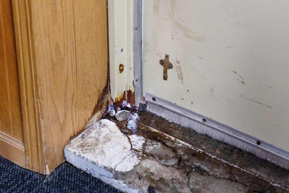 The door frame of a classroom inside a former transportation office has a gap that lets in cold air and moisture.