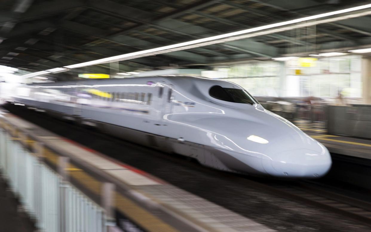 A Shinkansen bullet train travels through Shin-Kobe station in Kobe - Bloomberg