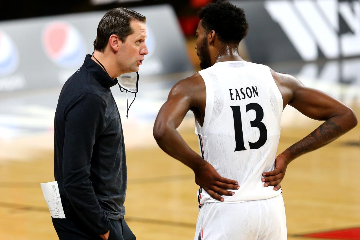 John Brannen, here with UC's Tari Eason, has come to grip with how his time as Bearcats head coach ended. "Though I know I did nothing to the level of getting fired, you can’t move on without being able to really accept what’s happened and be better for it," he said.