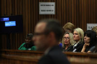 June Steenkamp, the mother of Reeva Steenkamp, third from right, looks towards Oscar Pistorius, foreground in the dock, as he listens to psychiatric evidence for his defense, during his ongoing murder trial in Pretoria, South Africa, Tuesday, May 13, 2014. The chief prosecutor in the murder trial of Oscar Pistorius has asked that the double-amputee runner be placed under psychiatric evaluation after an expert witness testified that he had an anxiety disorder. Pistorius is charged with the shooting death of his girlfriend Reeva Steenkamp on Valentine's Day in 2013. (AP Photo/Themba Hdebe, Pool)