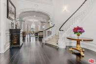 In the entry guests are greeted by a spiral staircase, beyond which are six bedrooms, eight bathrooms, a billiard room, and a four-car garage.