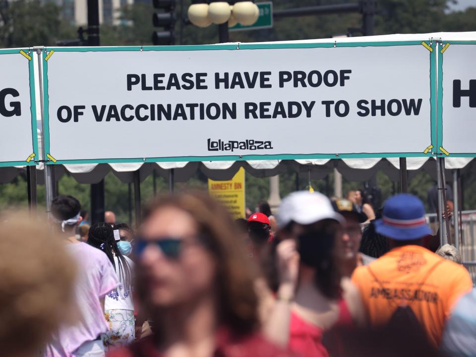 A booth at the Lollapalooza Music Festival reads, "Please have proof of vaccination ready to show"