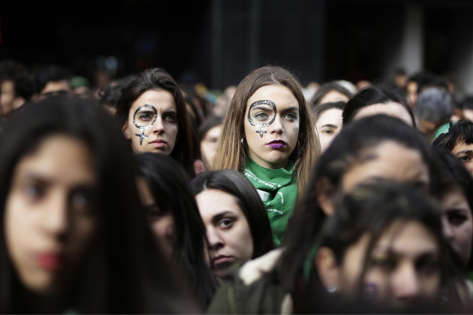 In this June 13, 2018 photo, women in favor of a campaign to expand legal abortions stage a demonstration outside Congress as lawmakers debate the measure, in Buenos Aires, Argentina. Leaders of the prestigious Argentina Medical Society said the measure would help reduce deaths among the estimated 400,000 to 500,000 women who now receive clandestine abortions each year.(AP Photo/Jorge Saenz)
