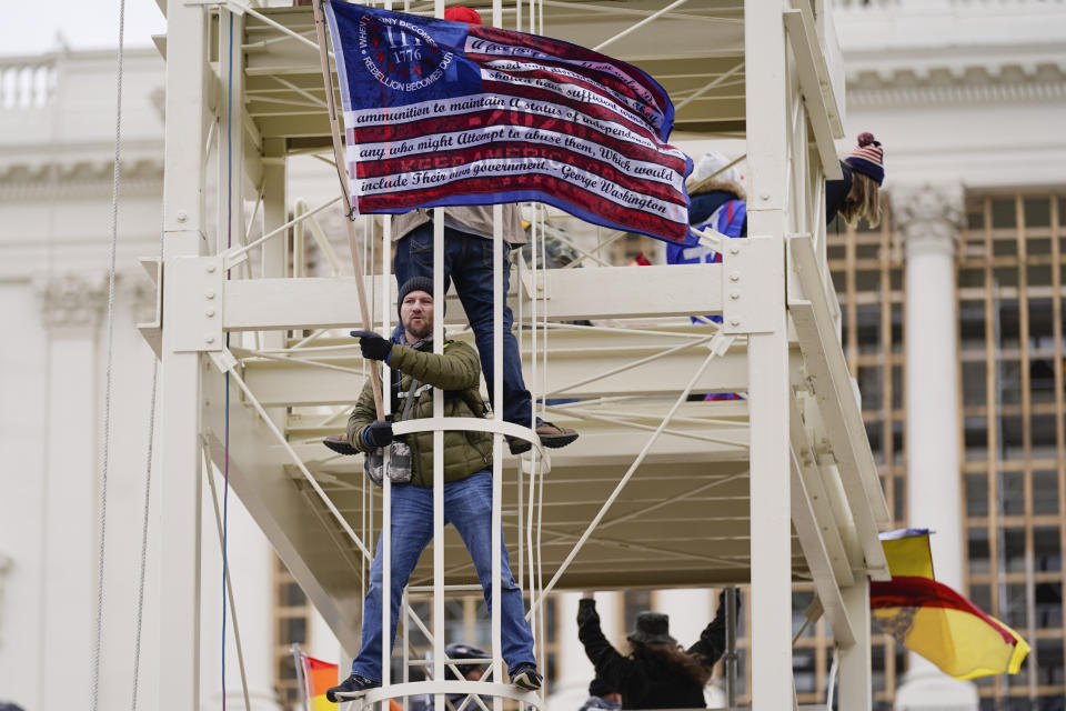 Rioters who support President Donald Trump wave a flag at the U.S. Capitol on Jan. 6, 2021, in Washington. (AP Photo/Julio Cortez)