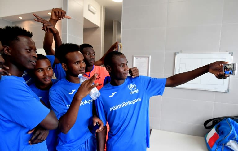 Young refugees capture the moment before taking on a team of former professional football players in Rome