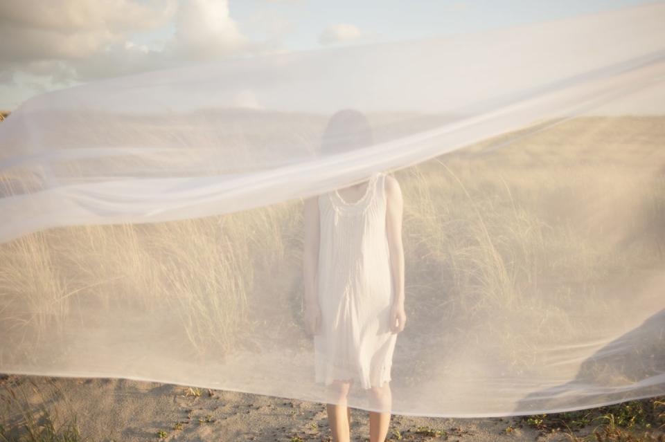 woman behind white veil