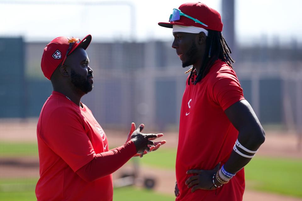 Dayton Dragons manager Vince Harrison talks with Cincinnati Reds shortstop Elly De La Cruz (44) during spring training workouts, Wednesday, Feb. 14, 2024, at the team’s spring training facility in Goodyear, Ariz.