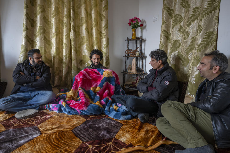 Fahad Shah, founder and editor of news portal The Kashmir Walla, sits with colleagues at his residence on the outskirts of Srinagar, Indian controlled Kashmir, Friday, Nov. 24, 2023. Indian authorities have released the prominent Kashmir journalist on bail nearly two years after he was arrested on accusations of publishing “anti-national content” and “glorifying terrorism.” (AP Photo/Dar Yasin)