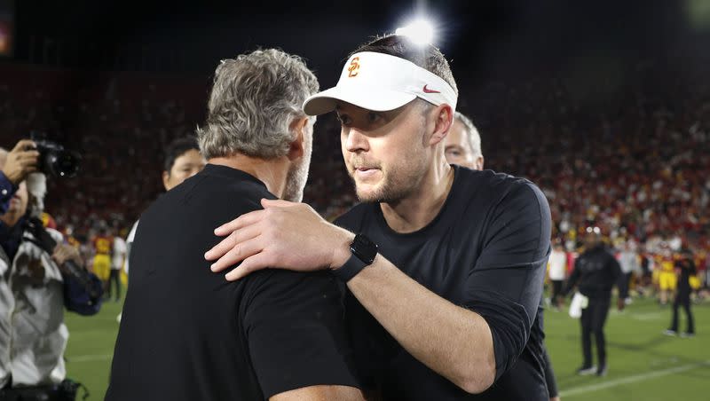 Southern California head coach Lincoln Riley, right, shakes hands with Utah head coach Kyle Whittingham after Utah defeated Southern California 34-32 in an NCAA college football game at the Los Angeles Memorial Coliseum on Saturday, Oct. 21, 2023.