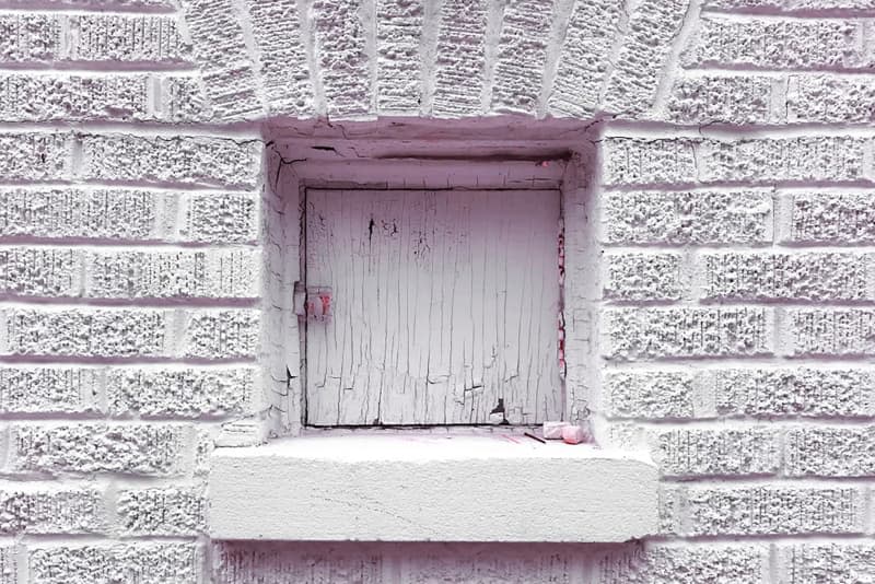 Light purple exterior brick with vintage milk delivery door