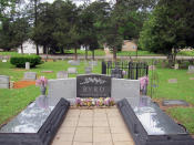 This Friday, April 12, 2019 photo shows the gravesite of James Byrd Jr. in Jasper, Texas. Byrd was killed on June 7, 1998, after he was chained to the back of a pickup truck and dragged for nearly three miles along a secluded road in the piney woods outside Jasper in what is considered one of the most gruesome hate crime murders in recent Texas history. In front of Byrd's gravesite, which was surrounded by a fence after being twice desecrated, sit the burial plots for his mother and father. Byrd's mother, Stella, died in 2010, while his father, James Sr., is still alive and resides in Jasper. (AP Photo/Juan Lozano)