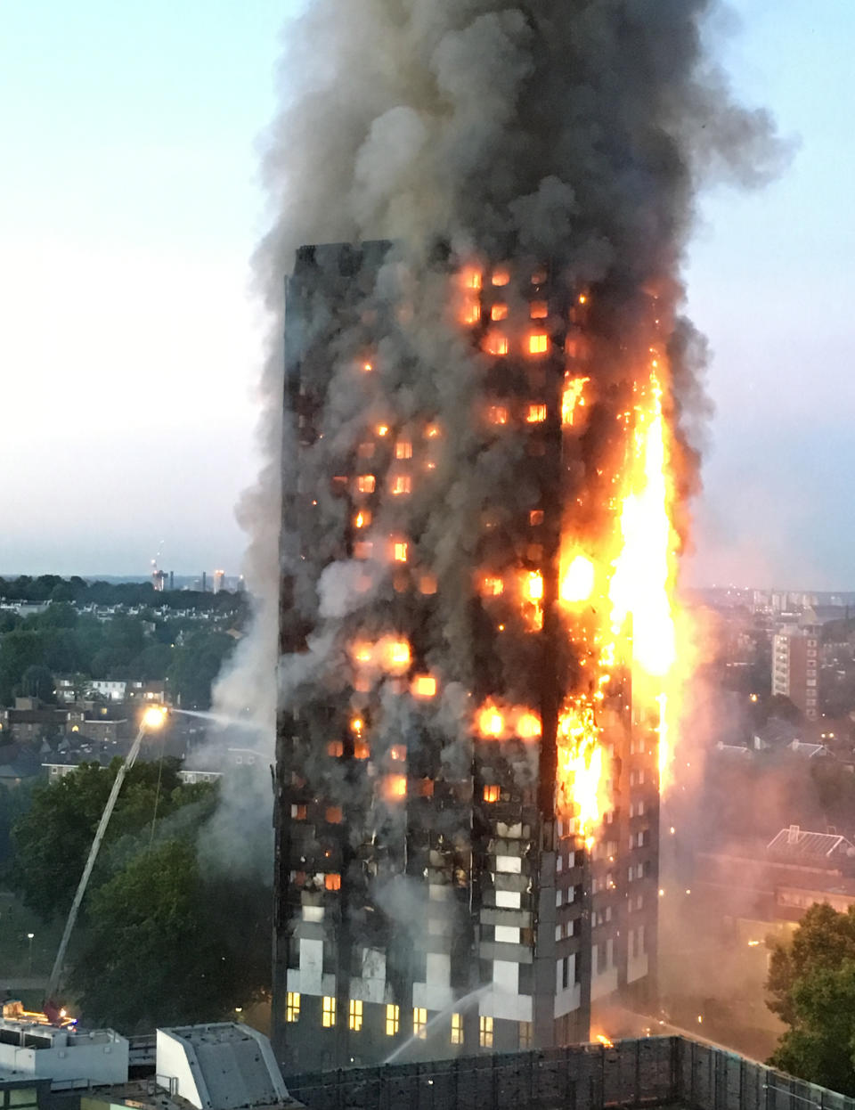 <p>In one of the most distressing photos of the year, thick smoke rises into the cloudless sky as over 200 firefighters from across London continue tackle the blaze at Grenfell Tower in North Kensington. Fire crews were called to the high-rise residential block on the Lancaster West housing estate in White City just before 1am on 14 June. The devastating fire killed 71 people. (REX/Shutterstock) </p>