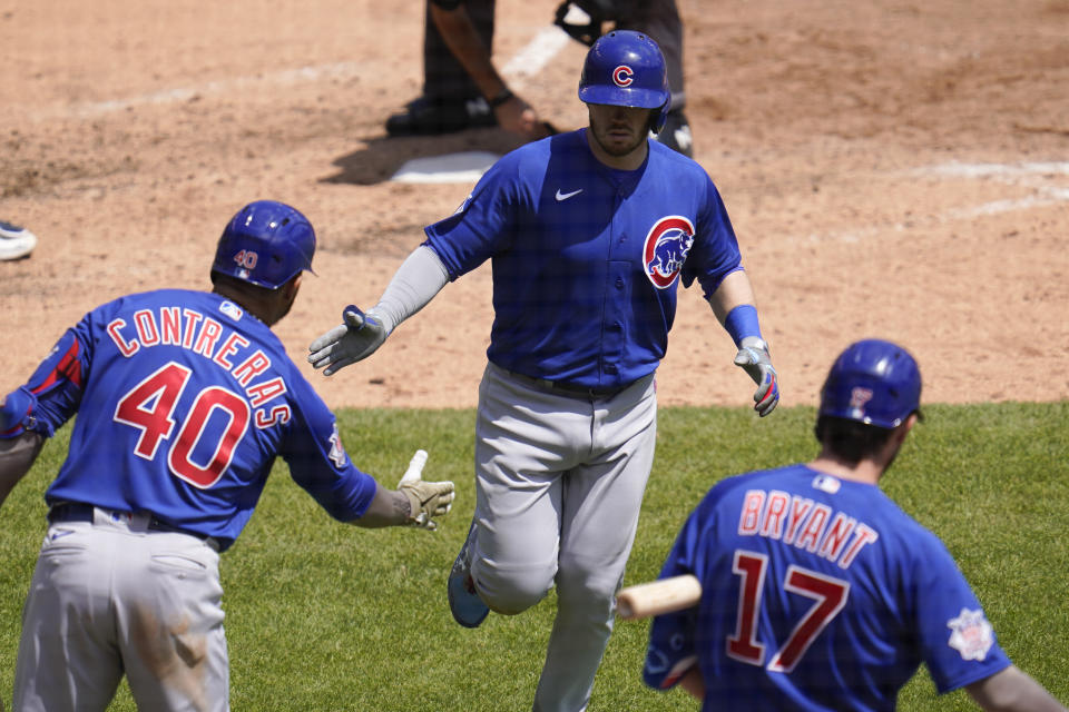 Chicago Cubs' Ian Happ, celebrates his solo home run with Willson Contreras (40) and Kris Bryant (17) in the sixth inning of a baseball game in Detroit, Sunday, May 16, 2021. (AP Photo/Paul Sancya)